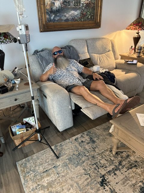 Chris giving a thumbs-up during an infusion